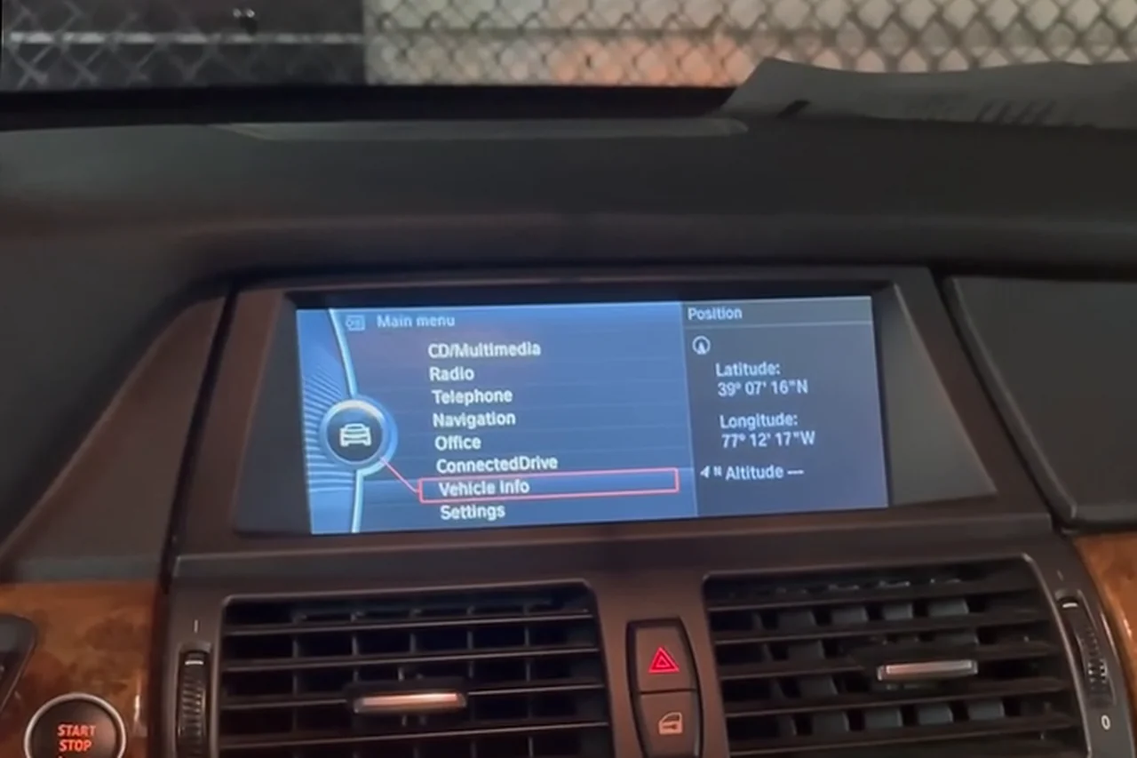 The original BMW display in the 2013 BMW X5, showing the factory iDrive main menu